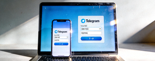 笔记本电脑与智能手机同时显示Telegram登录界面的场景图